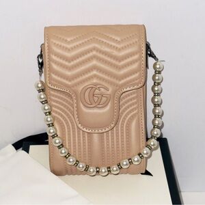 Gucci GG Marmont mini Clutch bag crafted in quilted matelassé leather